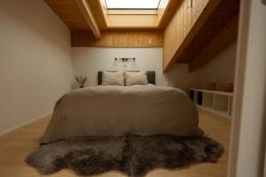 a bedroom with a bed with a furry rug at Victoria's Home - luxurious penthouse in Saas-Fee