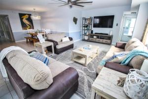 a living room with two couches and a tv at Oceanwalk 1-501 in New Smyrna Beach