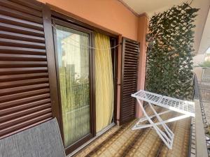 a balcony with a glass door and a table at Julija 1 in Igalo