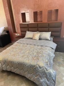 a bedroom with a large bed with a large headboard at villa founty in Agadir