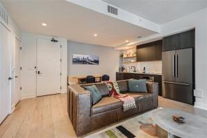 a living room with a couch and a kitchen at 2BD Condo-Rainey St-Best views-RT Pool in Austin