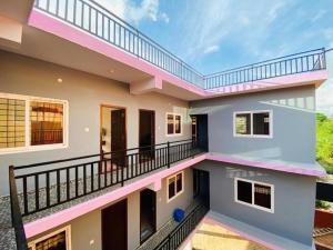a view of the outside of a house with a balcony at KODAGU MOUNTAIN VIEW Rooms in Madikeri