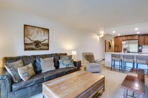 a living room with a couch and a table at Beautiful Breck Townhome with Pool 1 Mi to Main St! in Breckenridge