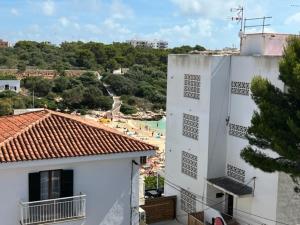 a white building with a view of a beach at Apartamentos Can Marsalet in Portocolom