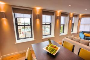 una sala da pranzo con tavolo e cesto di frutta di SoHot Stays Harbourside Suite 2nd Floor Sleeps 4 a Kent