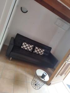 Eine schwarze Couch mit einer Computermaus drauf in der Unterkunft Le numéro 2 in Mirepeisset