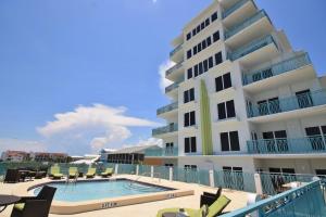 a large building with a swimming pool next to a building at The Wave 302 in New Smyrna Beach