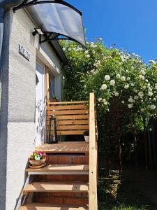 a wooden bench with a light on the side of a house at Ferienwohnung Rosengarten in Ballenstedt