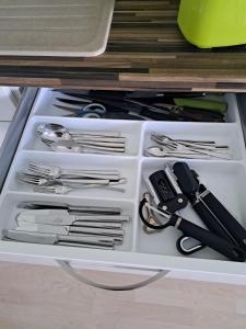 a drawer filled with silver utensils in a drawer at Ferienwohnung Rosengarten in Ballenstedt