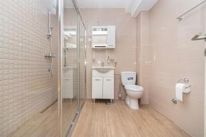 a bathroom with a toilet and a glass shower at Apartments Horizont in Budva