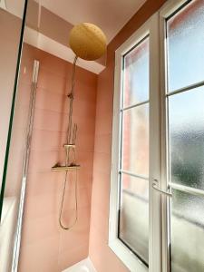 a bathroom with a shower and a window at Logement entier 75 m2 in Boulogne-Billancourt