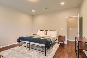a bedroom with a bed and a table in it at Serene 3BR Retreat near East Austin in Austin