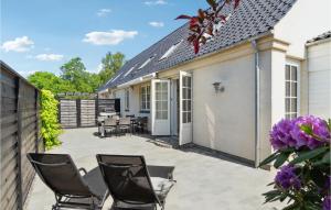 a patio with chairs and tables and a house at 3 Bedroom Gorgeous Home In Gilleleje in Gilleleje
