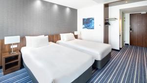 Postel nebo postele na pokoji v ubytování Holiday Inn Express Amsterdam Arena Towers by IHG