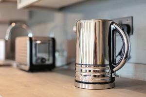 a silver coffee pot sitting on a kitchen counter at SoHot Stays The Penthouse Suite - Harbour Views - Sleeps 4 in Kent