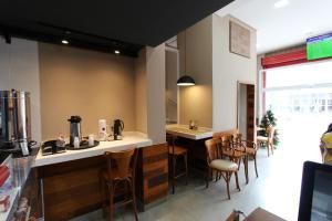 a kitchen with a bar and chairs in a restaurant at Vida Real Hostel in Sao Paulo