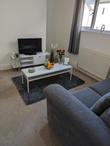 a living room with a couch and a coffee table at 1 bedroom flat in Gravesend in Kent