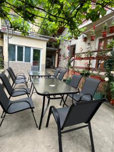 a group of tables and chairs on a patio at Casa Dina in Băile Herculane