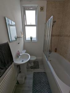 Kentにある1 bedroom flat in Gravesendのバスルーム(シンク、バスタブ、トイレ付)
