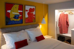 a bedroom with a bed with red and white pillows at The Frogs_Guest House in Athens