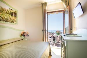 Cama ou camas em um quarto em Hotel Sardi