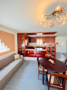 a living room with a couch and a table at Geka's apartment in Skala Rachoniou