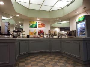 a fast food restaurant with a counter with a counter at Quality Inn Owen Sound in Owen Sound