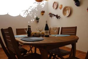 a wooden table with wine bottles and glasses on it at Casa Elena in Fuengirola