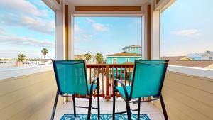 two chairs on a porch with a view of the ocean at BC604 Roomy Townhome, Outdoor Seating, Shared Heated Pool with Water Slide in Port Aransas