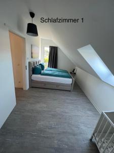 a bedroom with a bed in a attic at Doppelhaushälfte mit Terrasse in Lichtenhagen
