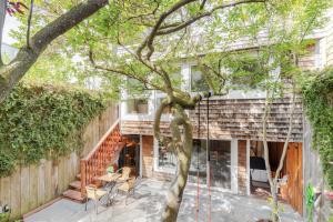 a house reconstruction with a tree in the foreground at STYLISH AND SPACIOUS 2ND Flr 2 BR VICTORIAN HOME in San Francisco