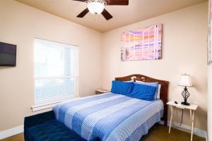 a bedroom with a bed and a ceiling fan at After Dune Delight in Port Aransas +31 photos