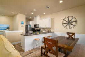 a kitchen and dining room with a table and chairs at After Dune Delight in Port Aransas