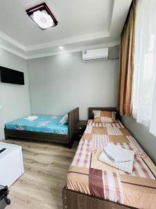 Postel nebo postele na pokoji v ubytování New Batumi