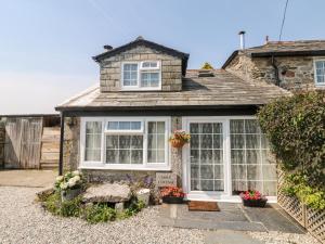 a house with a window and a bench at Mole Cottage in Liskeard