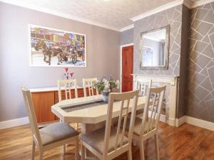 a dining room with a table and chairs and a mirror at Walpole House in Great Yarmouth
