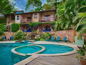 a resort with a swimming pool and a building at Pousada Vila Serrano in Lençóis