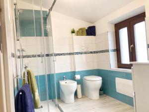 een badkamer met een toilet en een glazen douche bij AlgheroLux- Free Secured Parking for Cars and Motorbikes in Alghero