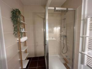 a bathroom with a shower and a bath tub at Gîte aux portes d'Angoulême in Champniers