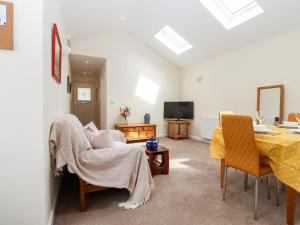 a living room with a table and chairs and a dining room at The Garden House Cottage in Whitstable