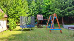 a yard with two playground equipment in the grass at Casa Aris Lepsa Vrancea in Lepşa