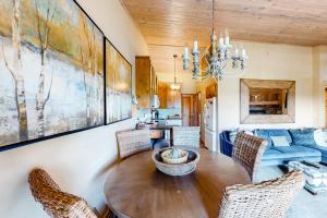 a dining room with a wooden table and chairs at Bay Point Hillside 16B in Whitefish