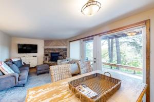 a living room with a couch and a table at Bay Point Hillside 16B in Whitefish