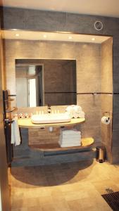 a bathroom with a sink and a mirror at ApartHotel Sainte-Marthe in Avignon