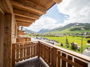 a view from the balcony of a house with a view of the mountains at Deschana Lodge in Livigno
