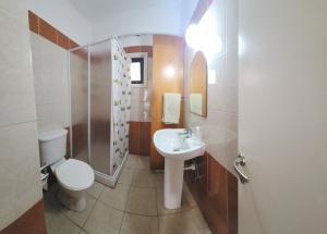 a bathroom with a sink and a toilet and a shower at Ayia Napa Cyprus in Paralimni +21 photos