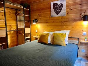 a bedroom with a bed with a wooden wall at Gites d'Armor in Treguidel