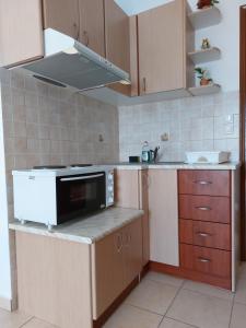 a kitchen with a stove and a microwave at Sunset Apartments in Kanali +22 photos