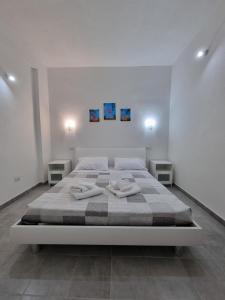 a bedroom with a bed with two towels on it at Mito apartment in Cagliari
