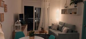 a living room with a couch and a table at Alegre apto con piscina, a 300m de la playa. in Blanes